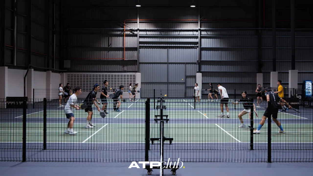 Players mid-rally across the premium courts at ATP Club, Masai